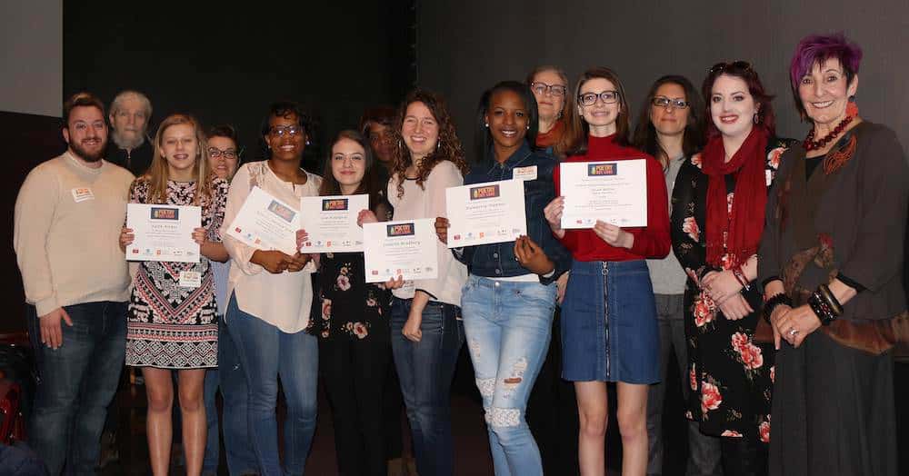 Poetry Out Loud competing students from 2017-2018, standing in a group with their certificates of participation.