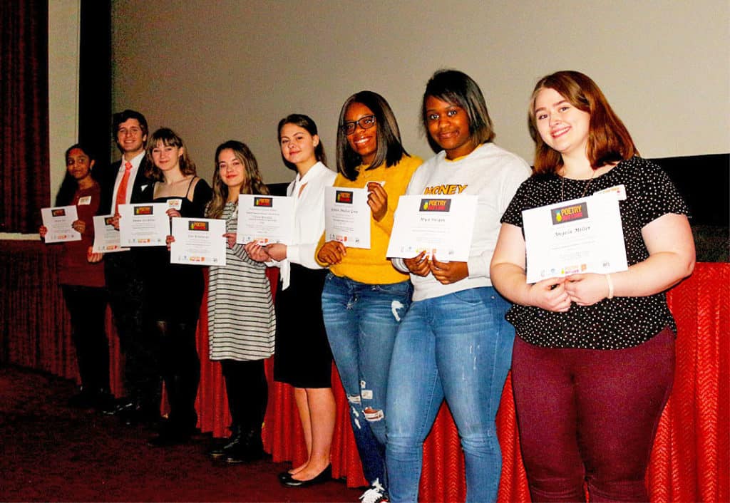 Poetry out loud, 2018-2019 participating students standing in a row with their certificates.
