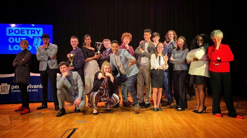 2020 Poetry Out Loud Pennsylvania Championship: a group of competing students and competition judges are standing on stage smiling.